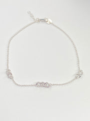 A delicate silver chain anklet with a alternative thicket link design with the cable link displayed on a clean white background.