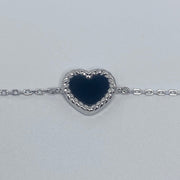 7 inches Sterling silver bracelet with black enamel heart and cubic zirconia accents close up of heart