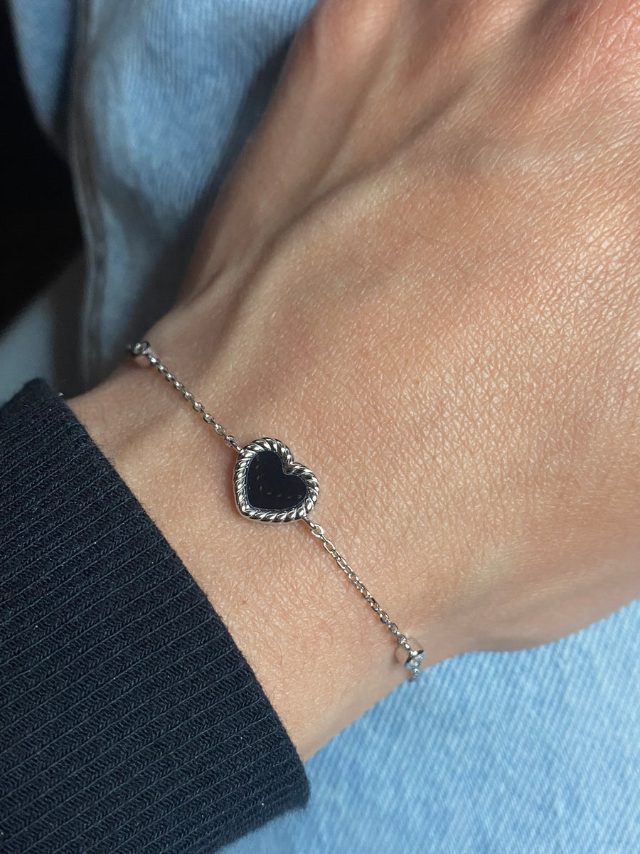 7 inches Sterling silver bracelet with black enamel heart and cubic zirconia accents worn on wrist