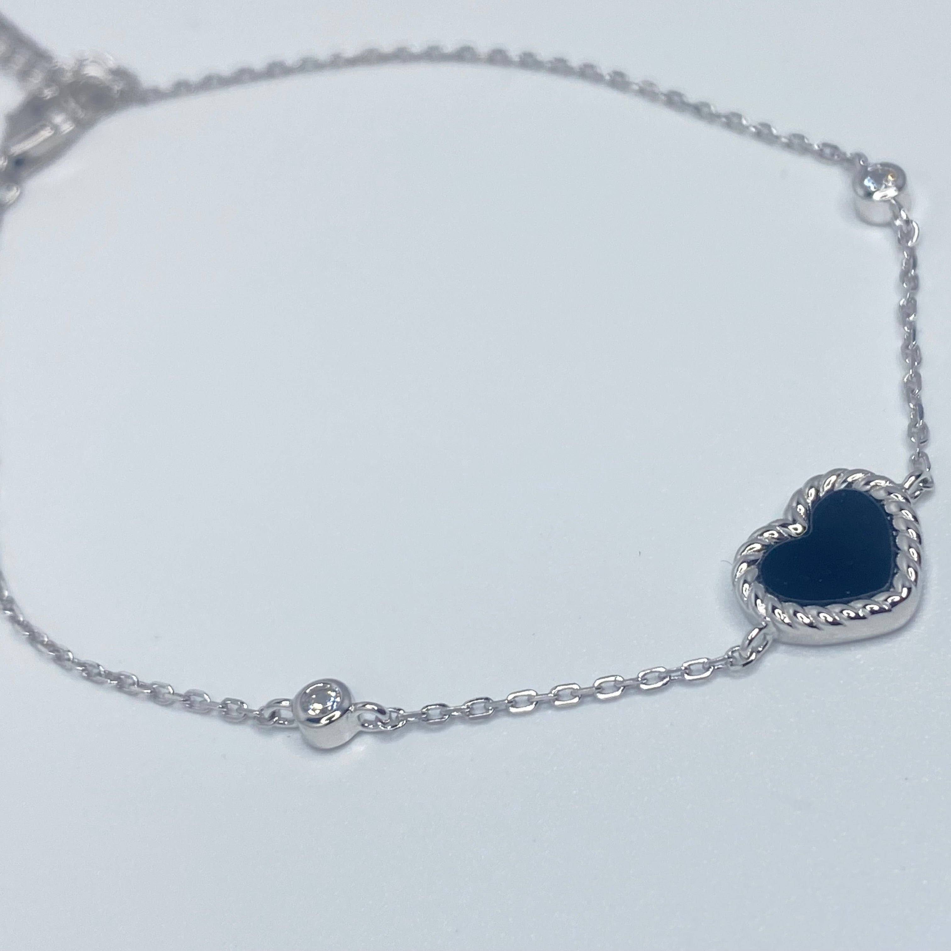 7 inches Sterling silver bracelet with black enamel heart and cubic zirconia accents side view