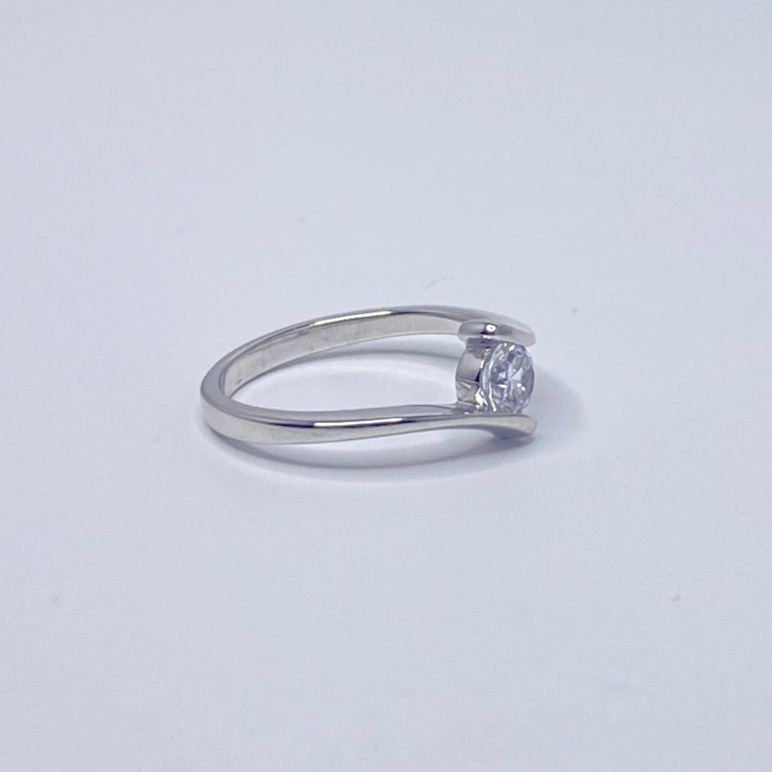 The Dianita Ring features a brilliant round-cut Cubic Zirconia set in a sleek tension setting
Handcrafted from 925 sterling silver and finished with rhodium plating for lasting brilliance. (side view)