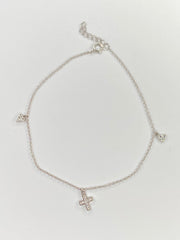 A delicate silver chain anklet with three small cross charms, displayed on a clean white background.