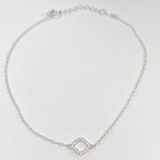 A delicate silver chain anklet featuring a small open diamond-shaped charm paved with tiny clear cubic zirconias, displayed on a clean white background.