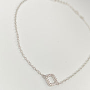 A delicate silver chain anklet featuring a small square charm encrusted with clear cubic zirconias, displayed on a clean white background.