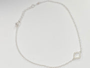 A delicate silver chain anklet with a small square link charm, displayed on a plain white background.