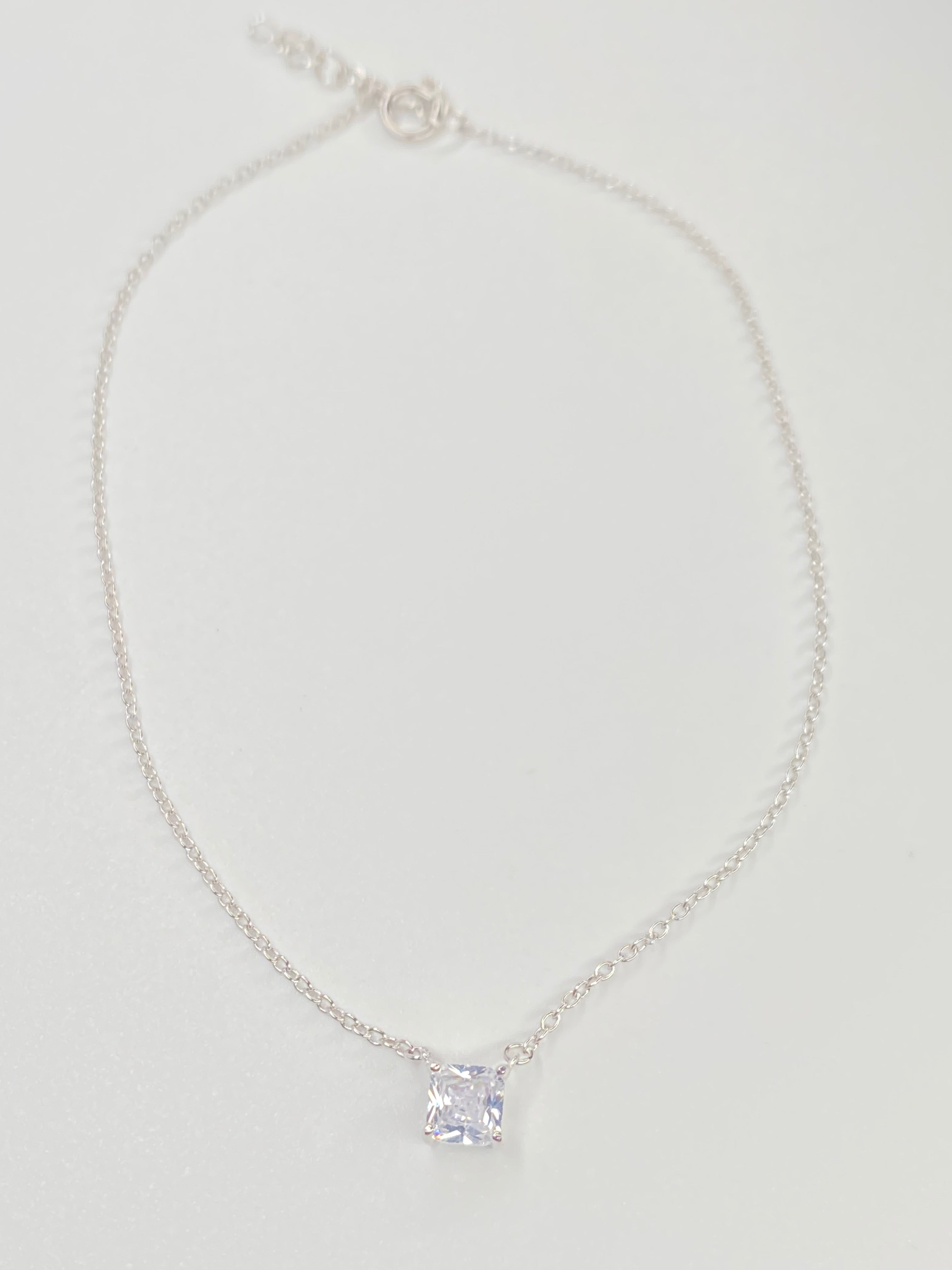 A delicate silver chain anklet with a single square-cut clear cubic zirconia pendant, displayed on a clean white background.
