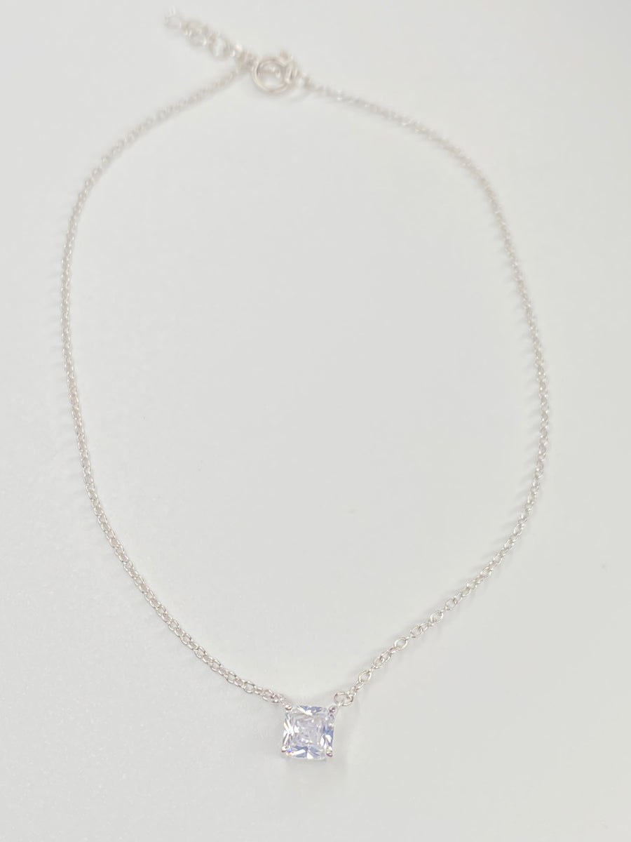 A delicate silver chain anklet with a single square-cut clear cubic zirconia pendant, displayed on a clean white background.